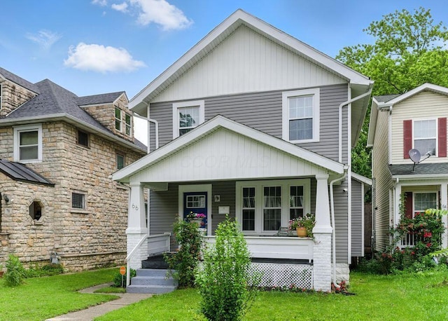 66 N Burgess Ave, Columbus, OH 43204 - view of front of home with a porch, a front yard, and stone siding