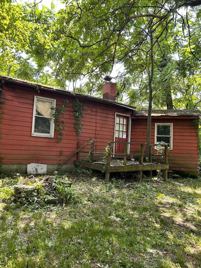 13428 King Rd NE, Thornville, OH 43076 - rear view of house featuring a chimney and a wooden deck