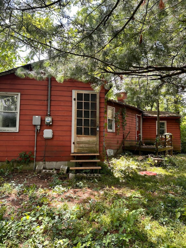 13428 King Rd NE, Thornville, OH 43076 - view of home's exterior with entry steps, a chimney, and a wooden deck