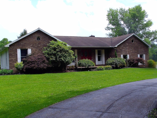 1110 Burr Oak Blvd, Nelsonville, OH 45764 - ranch-style home with brick siding, a front yard, and a chimney