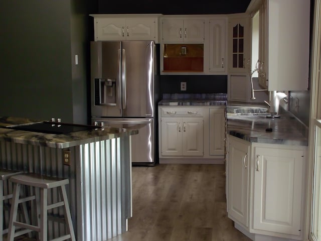 1110 Burr Oak Blvd, Nelsonville, OH 45764 - kitchen featuring stainless steel refrigerator with ice dispenser, open shelves, white cabinetry, light wood-type flooring, and glass insert cabinets