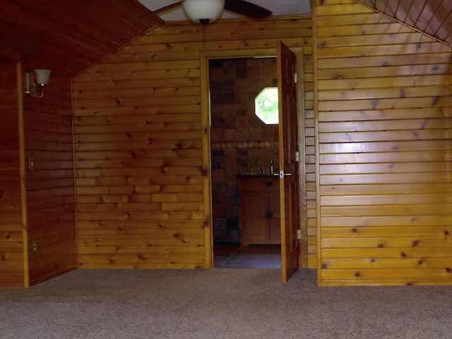 1110 Burr Oak Blvd, Nelsonville, OH 45764 - spare room featuring wooden walls, vaulted ceiling, carpet flooring, and ceiling fan