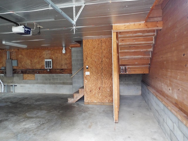 1110 Burr Oak Blvd, Nelsonville, OH 45764 - garage featuring a garage door opener and concrete block wall