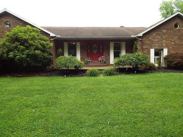1110 Burr Oak Blvd, Nelsonville, OH 45764 - ranch-style house with brick siding, a front yard, covered porch, and roof with shingles