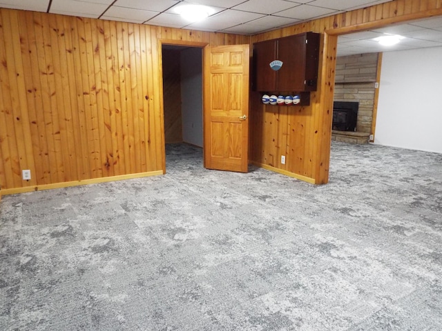 1110 Burr Oak Blvd, Nelsonville, OH 45764 - finished basement with carpet flooring, a paneled ceiling, a stone fireplace, and wooden walls
