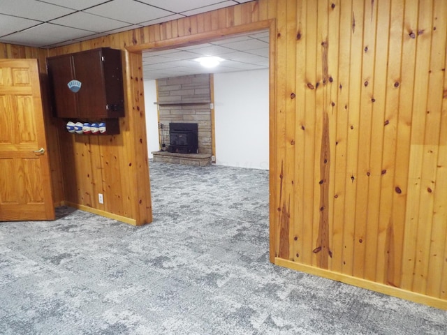 1110 Burr Oak Blvd, Nelsonville, OH 45764 - unfurnished room featuring carpet floors, wooden walls, a paneled ceiling, and a stone fireplace