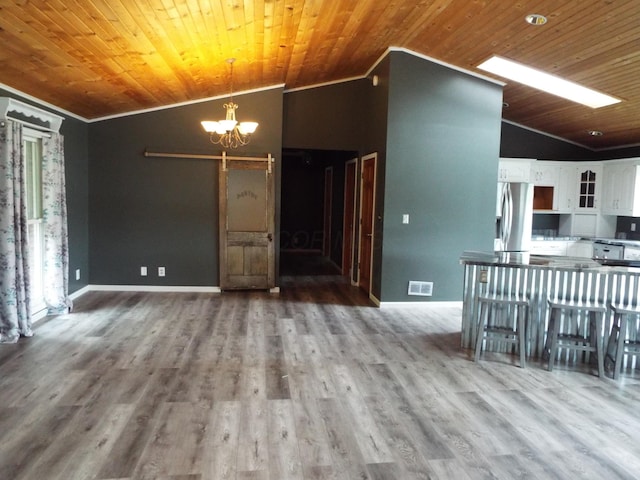 1110 Burr Oak Blvd, Nelsonville, OH 45764 - unfurnished living room with vaulted ceiling, crown molding, a chandelier, a barn door, and wooden ceiling