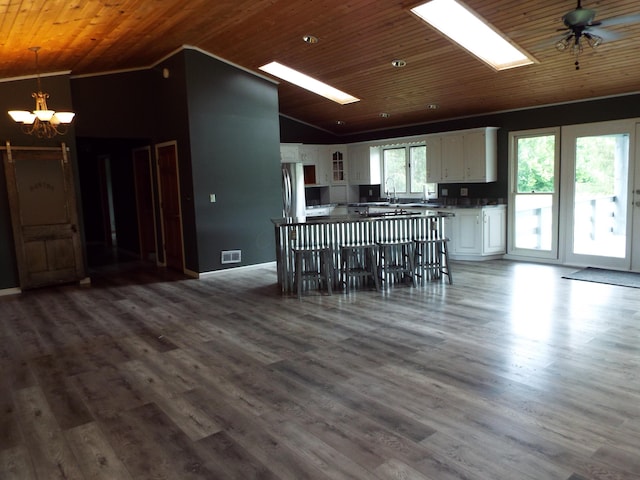 1110 Burr Oak Blvd, Nelsonville, OH 45764 - kitchen featuring lofted ceiling, a chandelier, white cabinets, wooden ceiling, and freestanding refrigerator