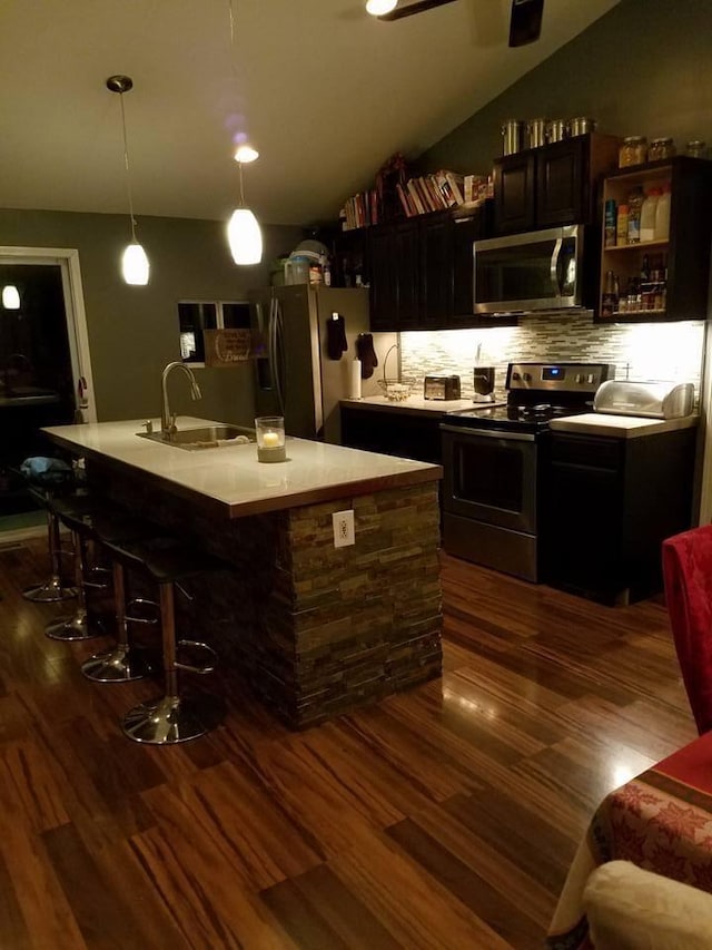 1261 Elm Park Pl, Galloway, OH 43119 - bar area with appliances with stainless steel finishes, dark wood finished floors, tasteful backsplash, and hanging light fixtures