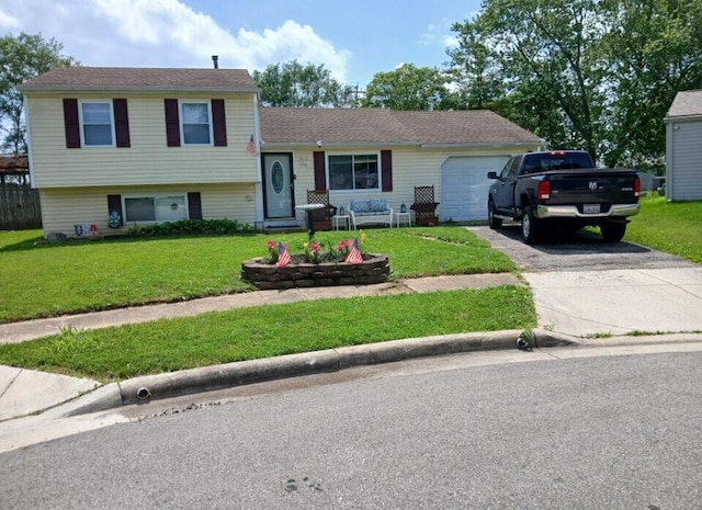 1261 Elm Park Pl, Galloway, OH 43119 - split level home with asphalt driveway, an attached garage, and a front yard
