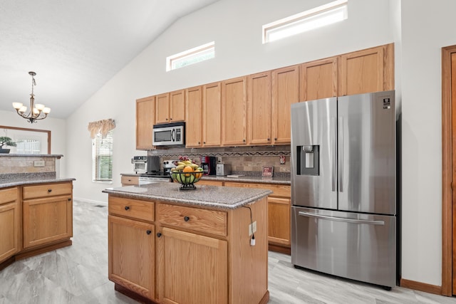 1296 Blacksmith Dr, Westerville, OH 43081 - kitchen featuring stainless steel appliances, tasteful backsplash, healthy amount of natural light, a chandelier, and high vaulted ceiling