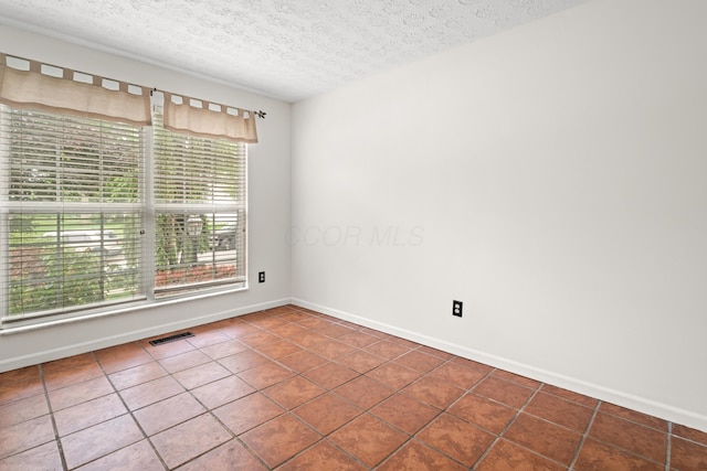 1296 Blacksmith Dr, Westerville, OH 43081 - empty room featuring tile patterned floors and a textured ceiling