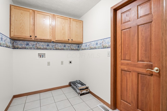 1296 Blacksmith Dr, Westerville, OH 43081 - laundry area featuring cabinet space, electric dryer hookup, washer hookup, light tile patterned floors, and a textured ceiling