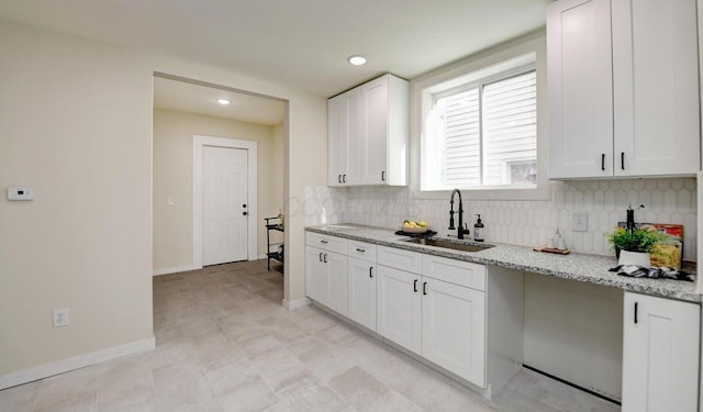 798 E Mithoff St, Columbus, OH 43206 - kitchen featuring backsplash, white cabinetry, light stone countertops, and recessed lighting