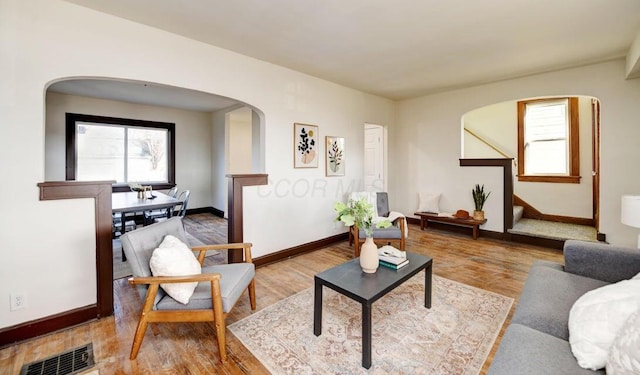 798 E Mithoff St, Columbus, OH 43206 - living room with arched walkways, wood finished floors, and stairs