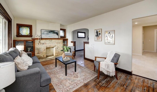 798 E Mithoff St, Columbus, OH 43206 - living area featuring arched walkways, a fireplace, wood finished floors, and lofted ceiling