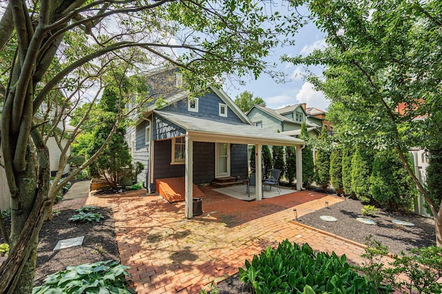 1066 City Park Ave, Columbus, OH 43206 - back of property featuring a patio, a shingled roof, and entry steps