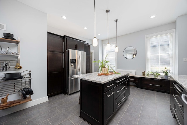 1066 City Park Ave, Columbus, OH 43206 - kitchen featuring stainless steel fridge with ice dispenser, healthy amount of natural light, tile patterned floors, light stone counters, and recessed lighting