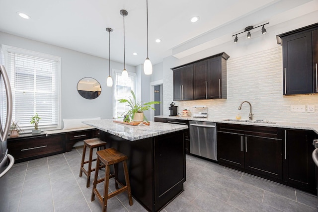 1066 City Park Ave, Columbus, OH 43206 - kitchen featuring stainless steel dishwasher, plenty of natural light, a center island, decorative backsplash, and recessed lighting