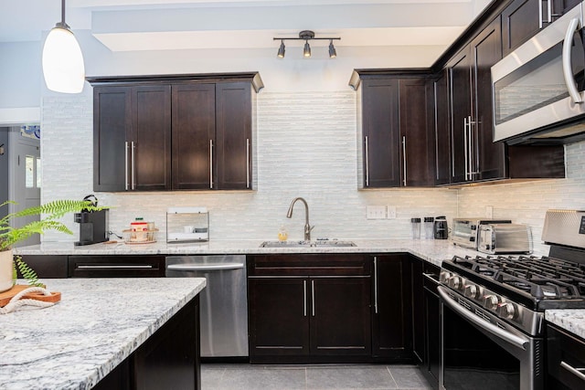 1066 City Park Ave, Columbus, OH 43206 - kitchen featuring stainless steel appliances, light stone countertops, decorative backsplash, and dark brown cabinets