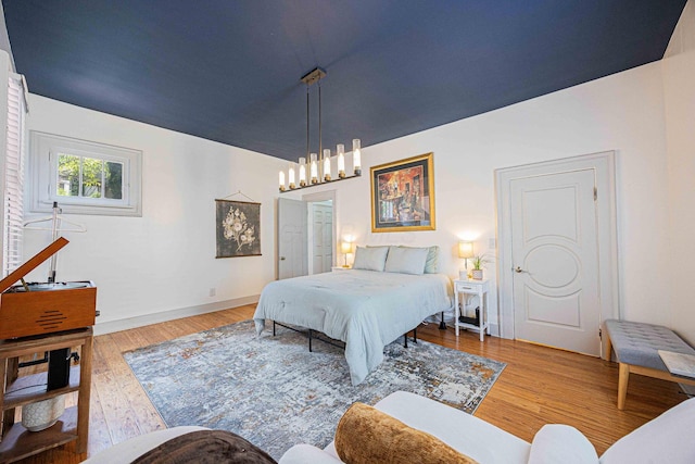 1066 City Park Ave, Columbus, OH 43206 - bedroom featuring wood finished floors and a chandelier
