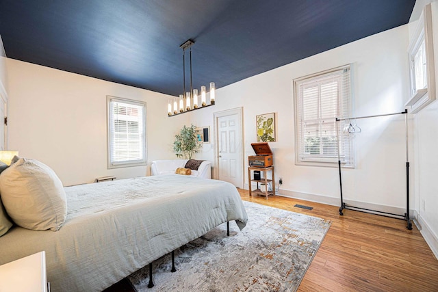 1066 City Park Ave, Columbus, OH 43206 - bedroom with a chandelier and wood finished floors