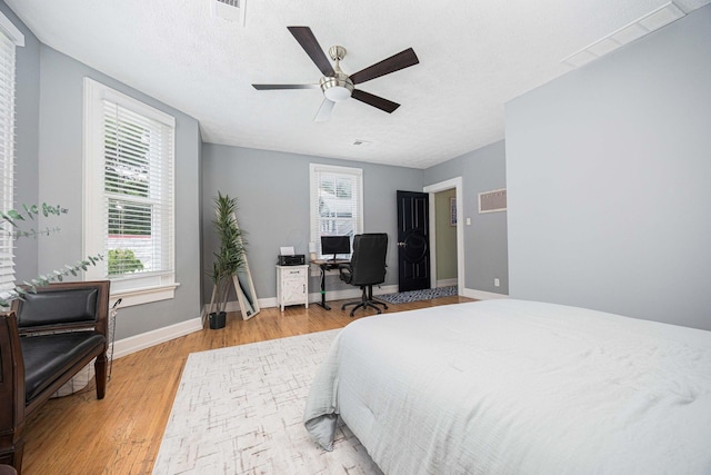 1066 City Park Ave, Columbus, OH 43206 - bedroom with light wood-style floors, multiple windows, and a ceiling fan