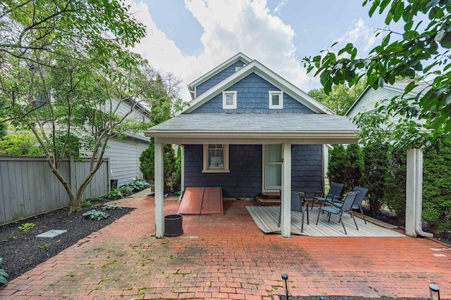 1066 City Park Ave, Columbus, OH 43206 - back of property featuring roof with shingles, a patio area, and entry steps