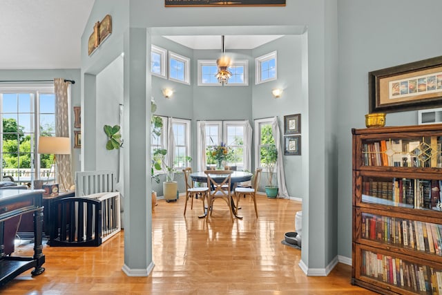 170 Joy Ln, Granville, OH 43023 - dining space featuring healthy amount of natural light, wood finished floors, a towering ceiling, and a chandelier