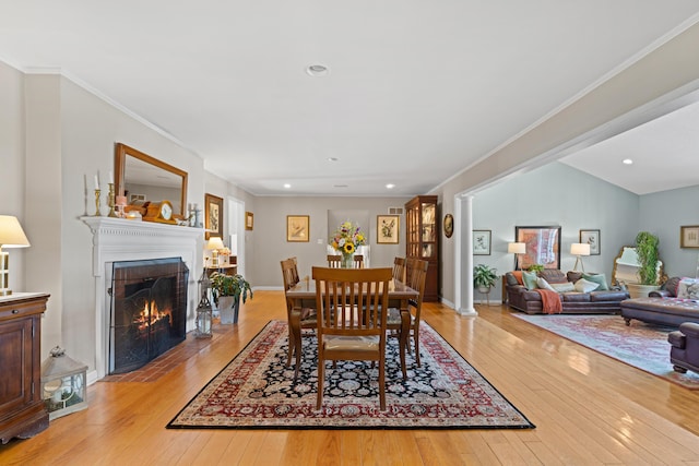 170 Joy Ln, Granville, OH 43023 - dining room with light wood-style floors, a fireplace with flush hearth, recessed lighting, and crown molding
