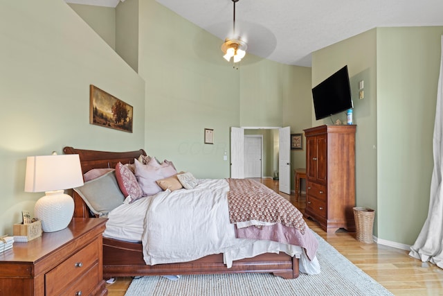 170 Joy Ln, Granville, OH 43023 - bedroom featuring light wood-style flooring, a towering ceiling, and ceiling fan