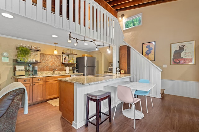 170 Joy Ln, Granville, OH 43023 - kitchen with freestanding refrigerator, light wood finished floors, light stone counters, backsplash, and a high ceiling