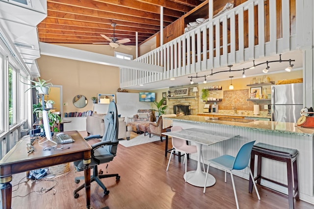 170 Joy Ln, Granville, OH 43023 - office space featuring ceiling fan, wood finished floors, a towering ceiling, and a stone fireplace