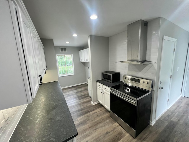 965 Francis Ave, Columbus, OH 43209 - kitchen featuring stainless steel appliances, wall chimney exhaust hood, decorative backsplash, dark wood-style floors, and recessed lighting