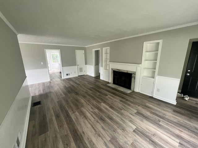 965 Francis Ave, Columbus, OH 43209 - unfurnished living room with built in features, a high end fireplace, dark wood-type flooring, wainscoting, and crown molding