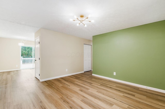 5309 Sundale Pl S, Columbus, OH 43232 - unfurnished room with light wood finished floors and a chandelier