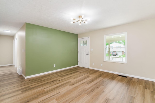5309 Sundale Pl S, Columbus, OH 43232 - foyer entrance featuring a chandelier and light wood-style flooring