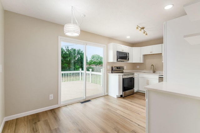 5309 Sundale Pl S, Columbus, OH 43232 - kitchen featuring stainless steel appliances, light countertops, light wood-type flooring, white cabinets, and recessed lighting