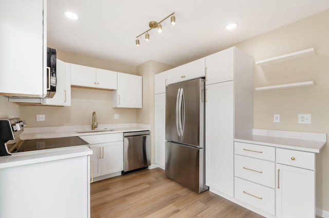 5309 Sundale Pl S, Columbus, OH 43232 - kitchen with stainless steel appliances, open shelves, white cabinets, light wood finished floors, and light countertops