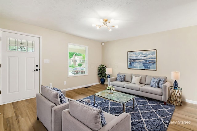 5309 Sundale Pl S, Columbus, OH 43232 - living room with a chandelier and light wood finished floors