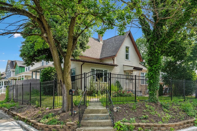 2350 Indiana Ave, Columbus, OH 43202 - view of front of property with a fenced front yard, a shingled roof, a gate, and a chimney