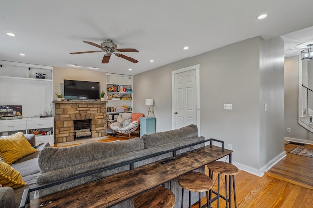 2350 Indiana Ave, Columbus, OH 43202 - living room featuring ceiling fan, light wood-type flooring, a stone fireplace, stairs, and recessed lighting