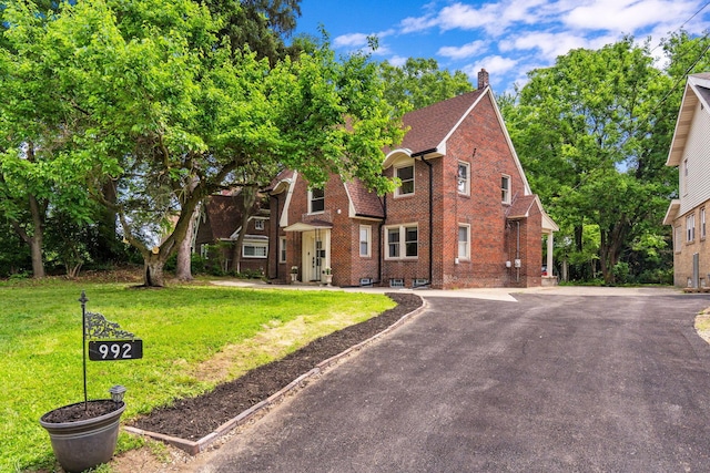 992 N Nelson Rd, Columbus, OH 43219 - view of front of property featuring brick siding, a front lawn, and a chimney