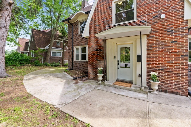 992 N Nelson Rd, Columbus, OH 43219 - doorway to property with brick siding, a patio, and a chimney