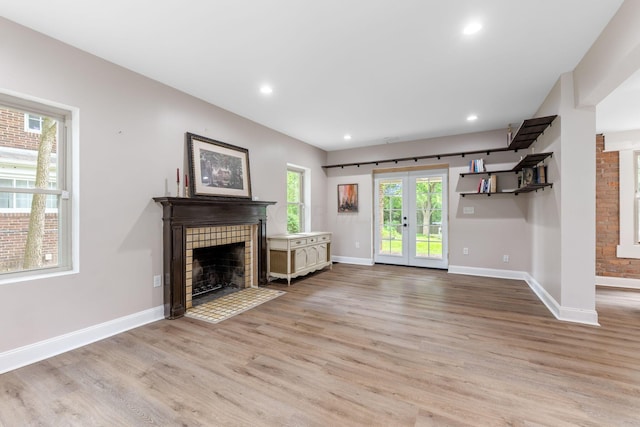 992 N Nelson Rd, Columbus, OH 43219 - unfurnished living room with a fireplace, light wood-style floors, recessed lighting, and french doors