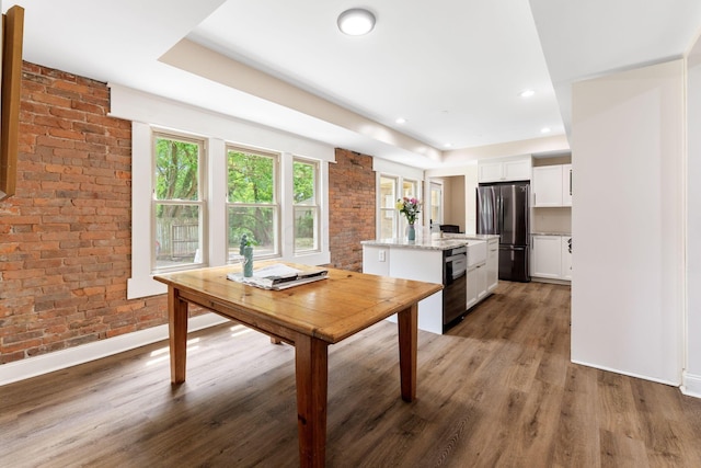 992 N Nelson Rd, Columbus, OH 43219 - dining room featuring brick wall, wood finished floors, and recessed lighting
