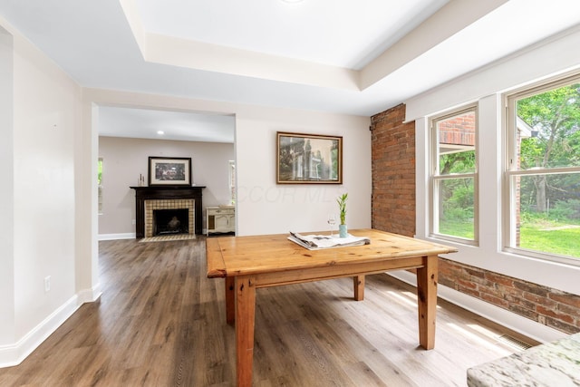 992 N Nelson Rd, Columbus, OH 43219 - office area with brick wall, wood finished floors, a fireplace, and a raised ceiling