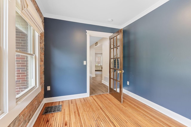 992 N Nelson Rd, Columbus, OH 43219 - empty room featuring hardwood / wood-style floors, ornamental molding, and french doors