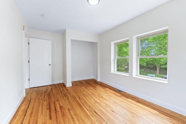 992 N Nelson Rd, Columbus, OH 43219 - unfurnished bedroom with light wood-style floors and a closet