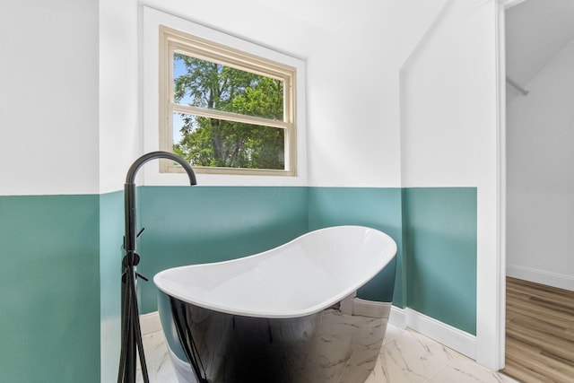 992 N Nelson Rd, Columbus, OH 43219 - bathroom featuring a freestanding bath and marble finish flooring